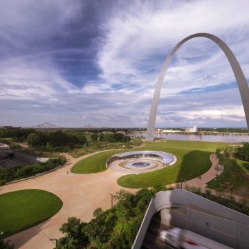 view of the st louis arch, visitor center, and skyline