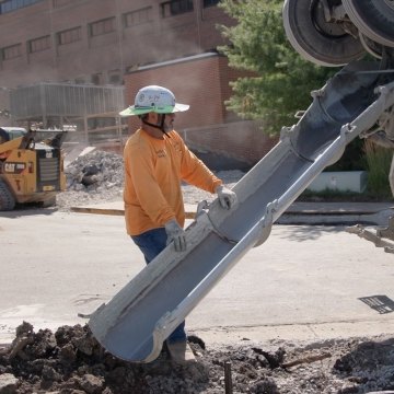 A person pouring concrete