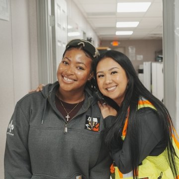 Two people smiling and posing for a photo