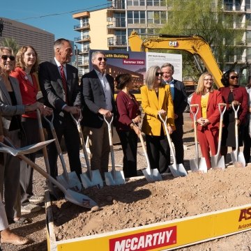 A group of people standing with ceremonial shovels