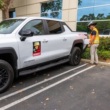 A person using a charger on an electric vehicle