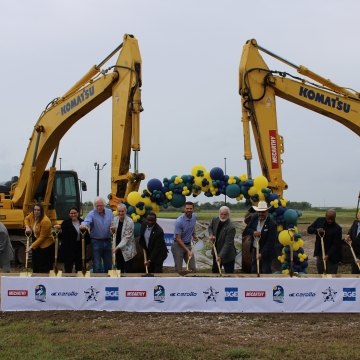 A group of people with shovels celebrating a groundbreaking