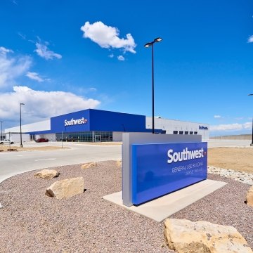 Image of the exterior of the building and a Southwest Airlines sign in the foreground.